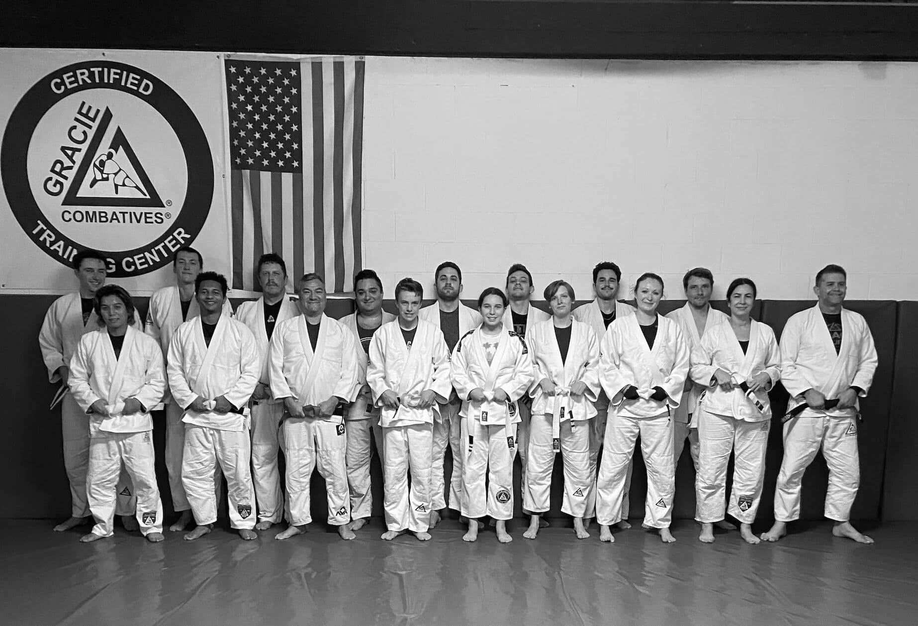 Gracie Jiu-Jitsu La Jolla students in front of the Certified Training Center logo