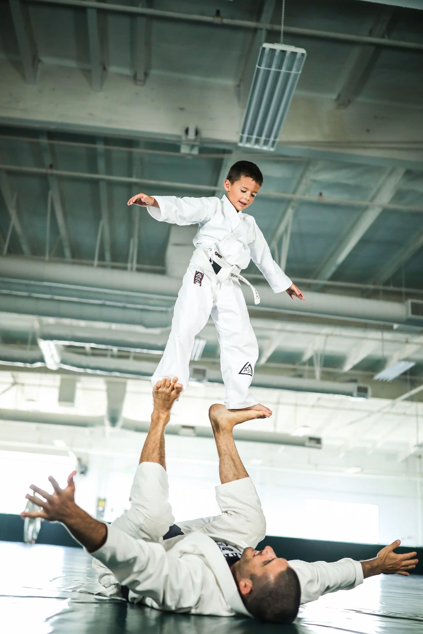 Child being lifted in a playful drill